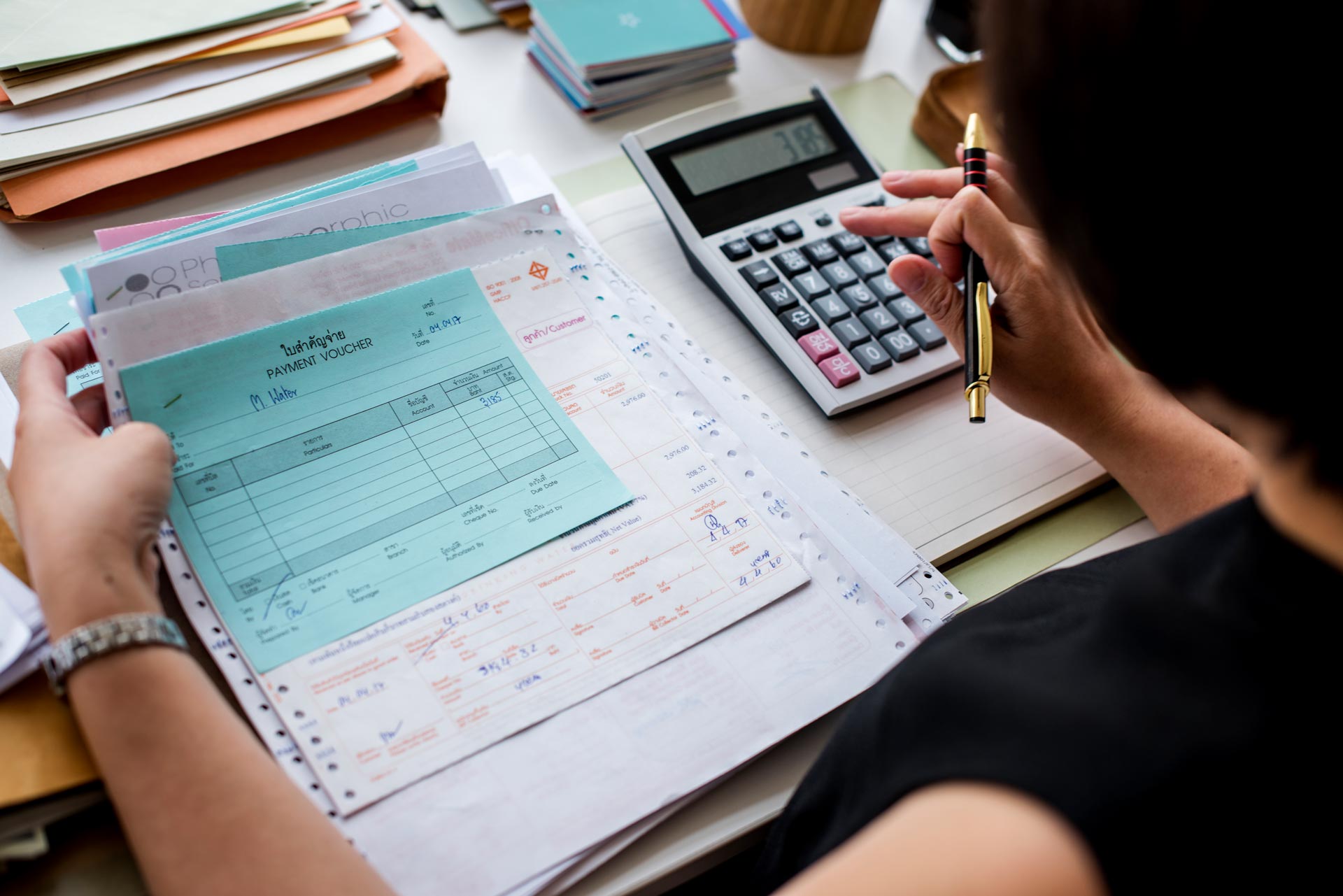 asian woman working through paperwork